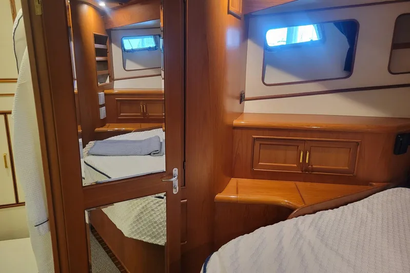 Miss Daisy Yacht Photos Pics Luxurious 2005 Fleming Pilothouse yacht interior with wood finish and cozy bedding.