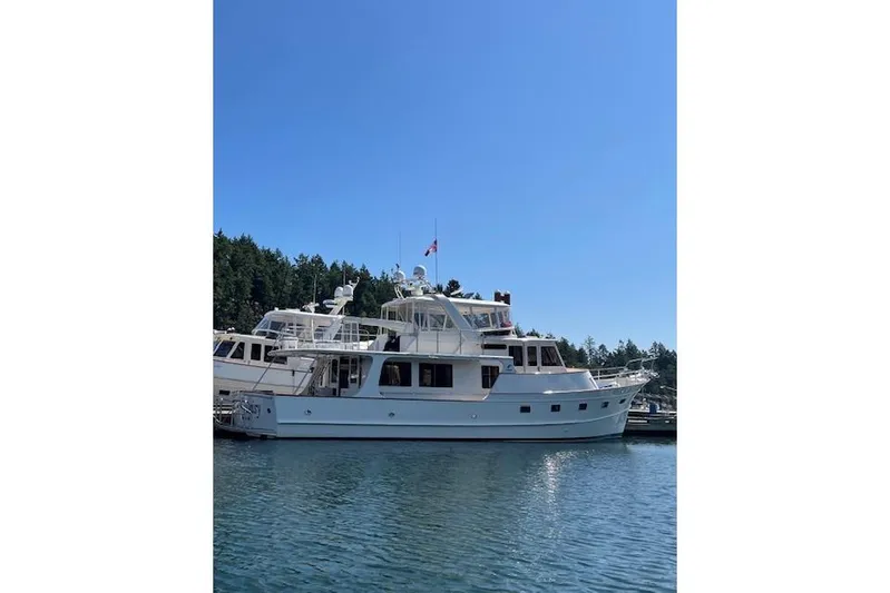 Miss Daisy Yacht Photos Pics Luxury 2005 Fleming yacht docked in serene marina under clear blue sky.