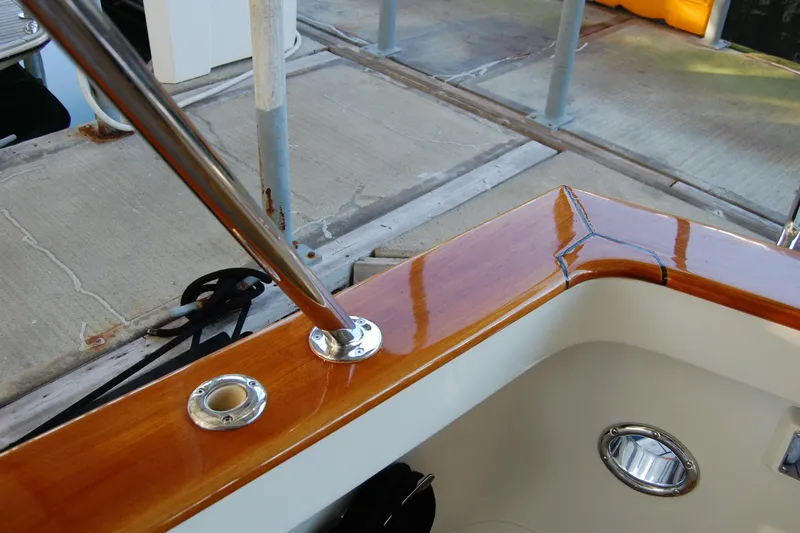 Miss Daisy Yacht Photos Pics Polished wooden boat railing with metal fittings, Fleming 2005 model, dockside view.