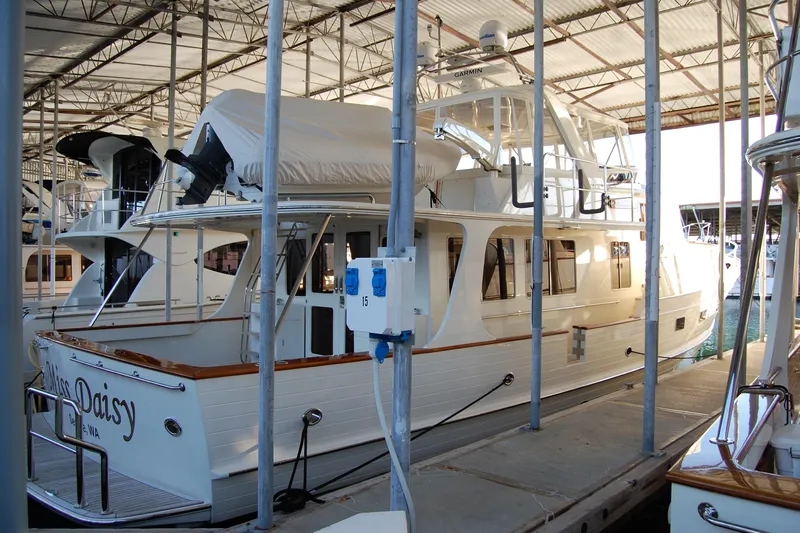 Miss Daisy Yacht Photos Pics Luxury 2005 Fleming yacht docked in marina under covered shelter.
