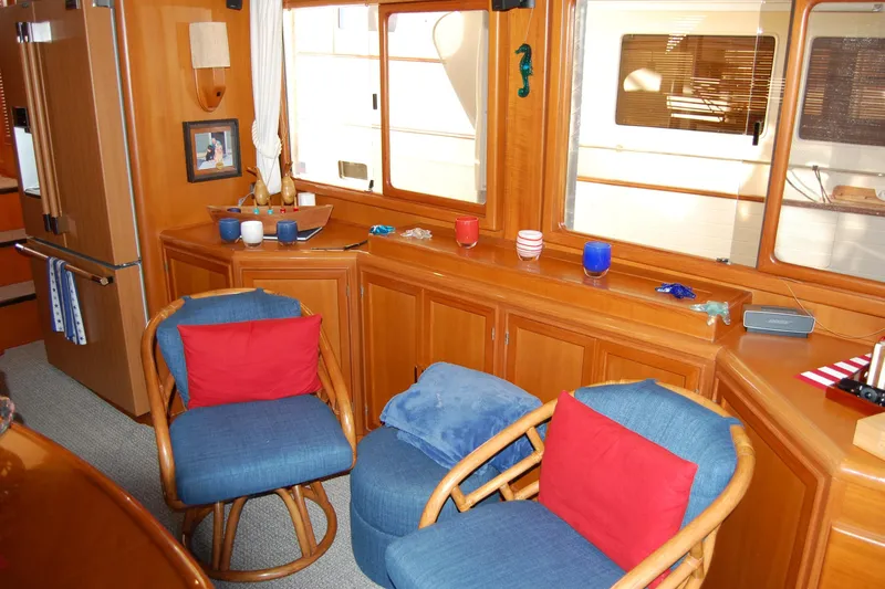 Miss Daisy Yacht Photos Pics Interior of a 2005 Fleming yacht with cozy seating and nautical decor.