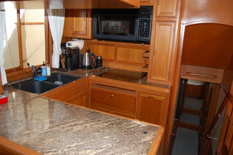 Miss Daisy Yacht Photos Pics Luxurious 2005 Fleming yacht kitchen with wooden cabinetry and modern appliances.