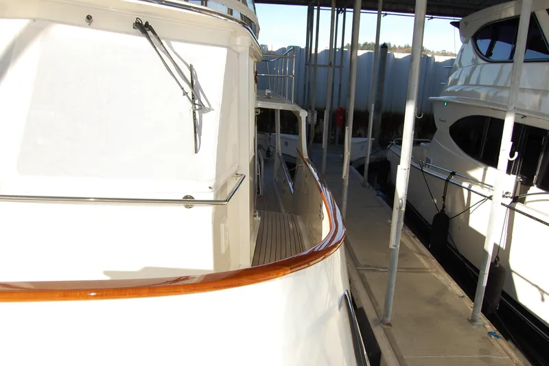 Miss Daisy Yacht Photos Pics 2005 Fleming yacht docked in marina, showcasing sleek design and polished wood accents.