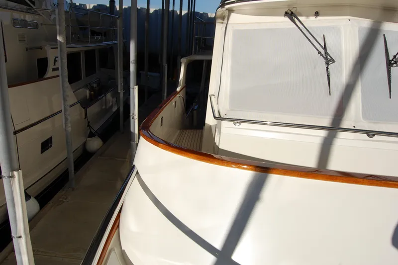 Miss Daisy Yacht Photos Pics 2005 Fleming yacht docked in marina, showcasing sleek design and polished wood accents.