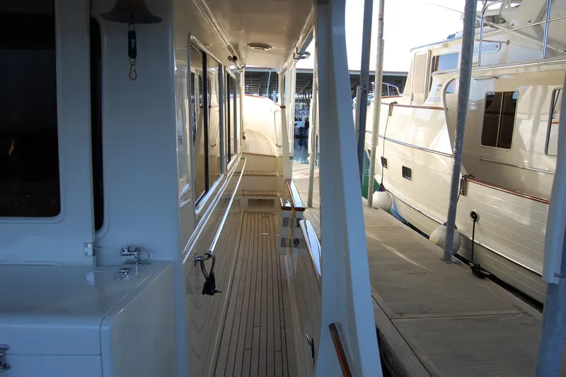 Miss Daisy Yacht Photos Pics Side deck of a 2005 Fleming yacht docked at a marina.