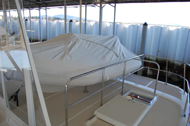 Miss Daisy Yacht Photos Pics Covered boat on deck, Fleming 2005, in marina with mountain view.