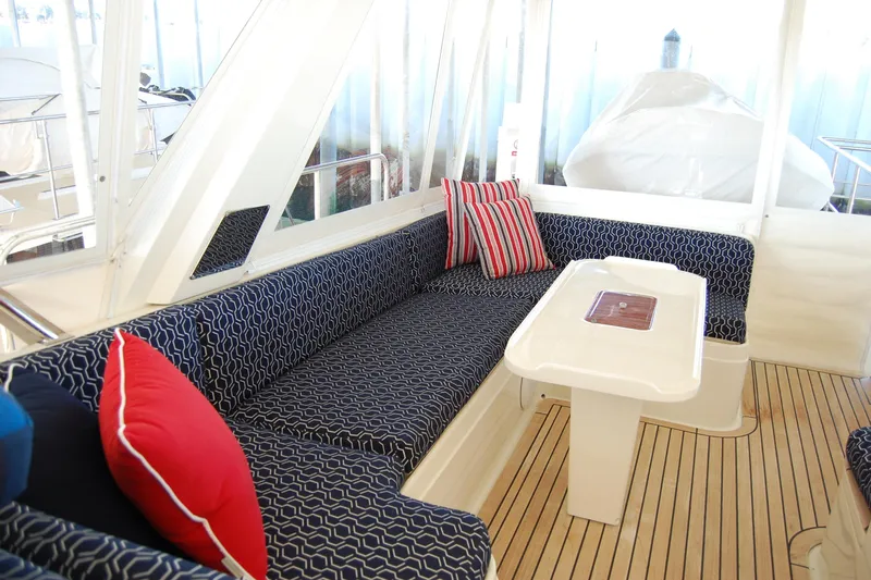 Miss Daisy Yacht Photos Pics Luxurious 2005 Fleming yacht interior with patterned seating, colorful cushions, and sleek wooden flooring.