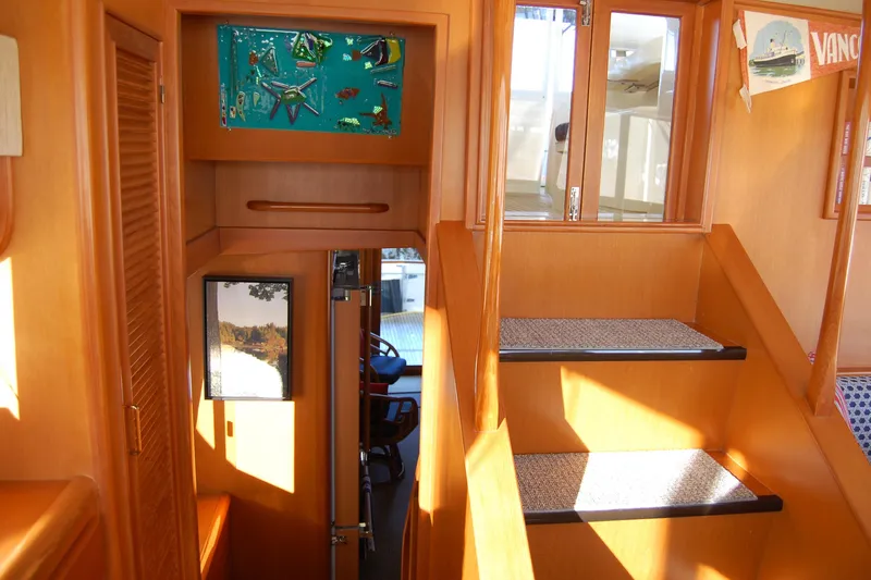 Miss Daisy Yacht Photos Pics Interior of a 2005 Fleming boat with wooden stairs and decorative elements.