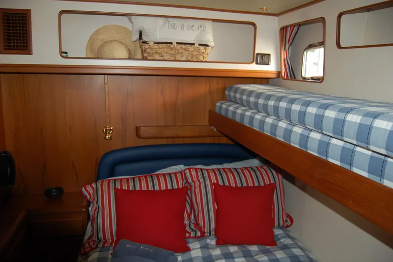 Miss Daisy Yacht Photos Pics Cozy 2005 Fleming yacht cabin with striped bedding and wooden accents.