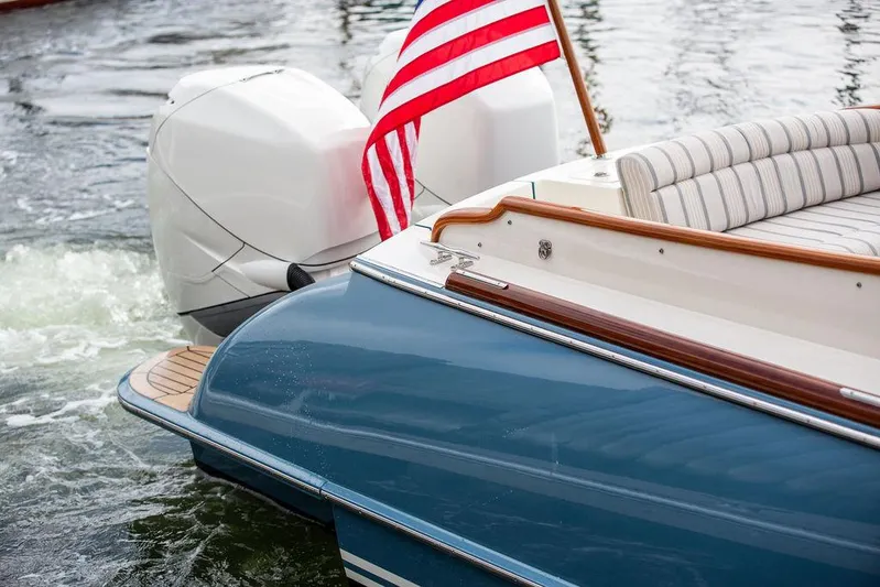 Sublime Yacht Photos Pics Hinckley 35 boat, 2022 model, with American flag and twin engines on water.
