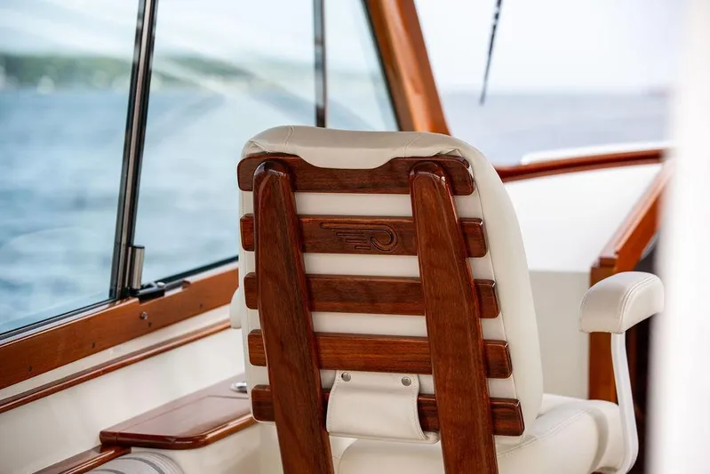 Sublime Yacht Photos Pics Captain's chair on 2022 Hinckley 35 boat, featuring elegant wood and leather design.