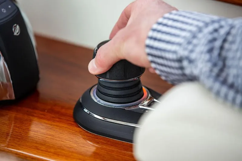 Sublime Yacht Photos Pics Hand operating joystick control on 2022 Hinckley 35 boat dashboard.
