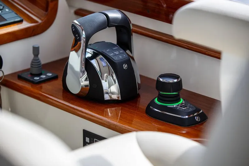 Sublime Yacht Photos Pics Hinckley 35 yacht controls, 2022 model, featuring sleek throttle and joystick on wooden panel.