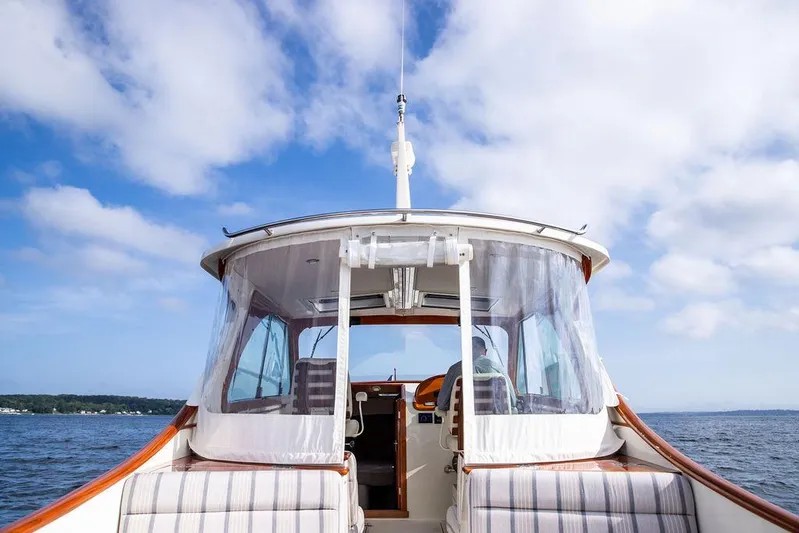 Sublime Yacht Photos Pics Hinckley 35 boat cruising on open water under a blue sky, 2022 model.