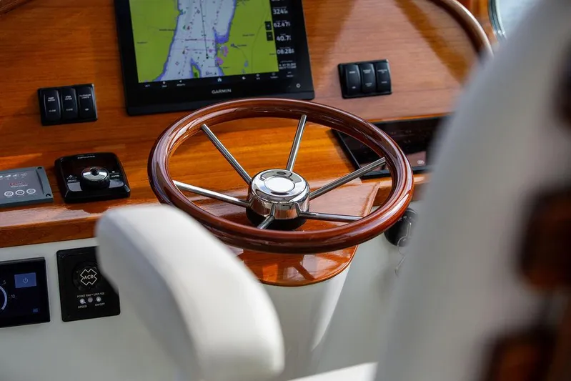Sublime Yacht Photos Pics Steering wheel and dashboard of 2022 Hinckley 35 boat with navigation display.