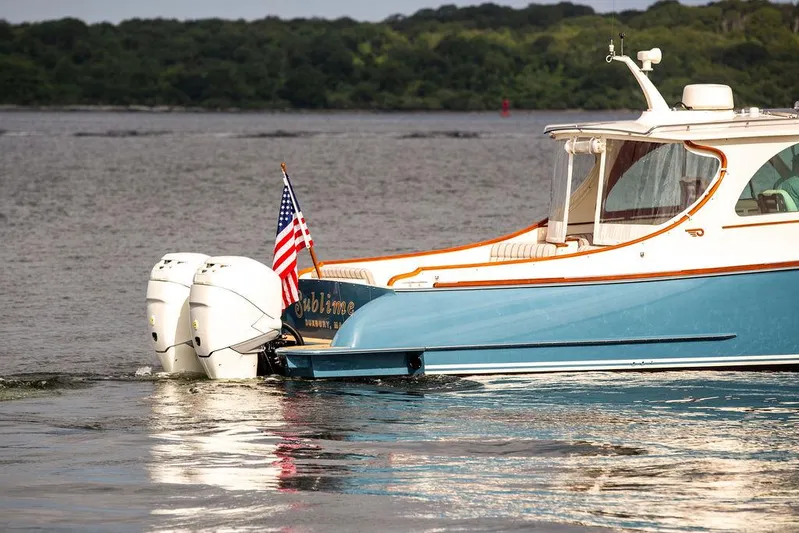 Sublime Yacht Photos Pics 2022 Hinckley 35 boat with dual engines on a calm lake.