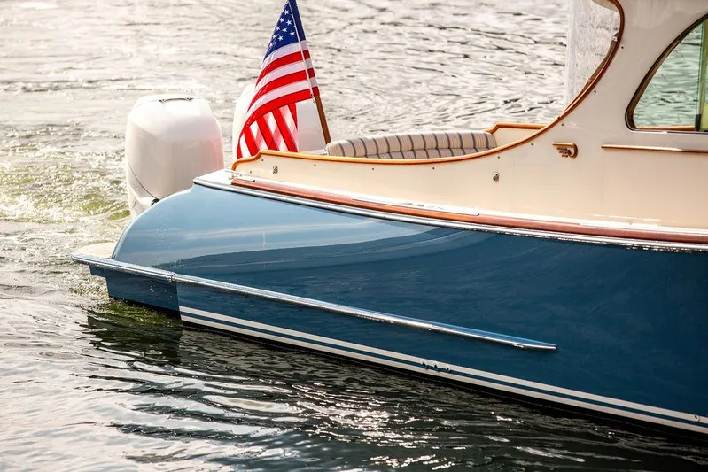 Sublime Yacht Photos Pics 2022 Hinckley 35 boat with American flag on water.