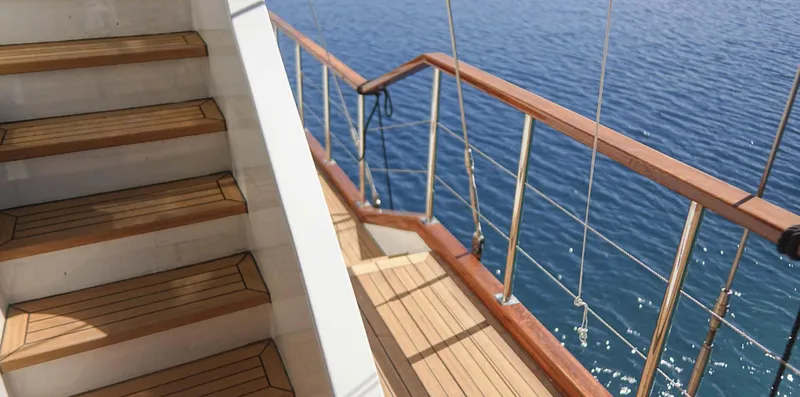  Yacht Photos Pics Wooden deck and stairs on a 2023 Gulet yacht overlooking the sea.