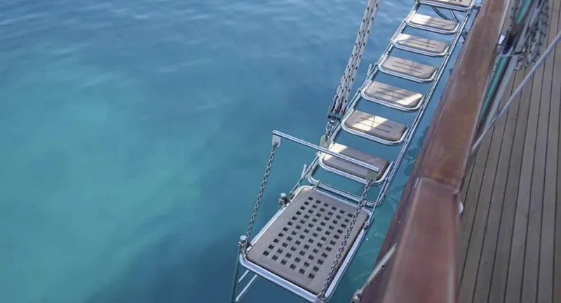  Yacht Photos Pics Gangway of 2023 Gulet yacht over clear blue water.