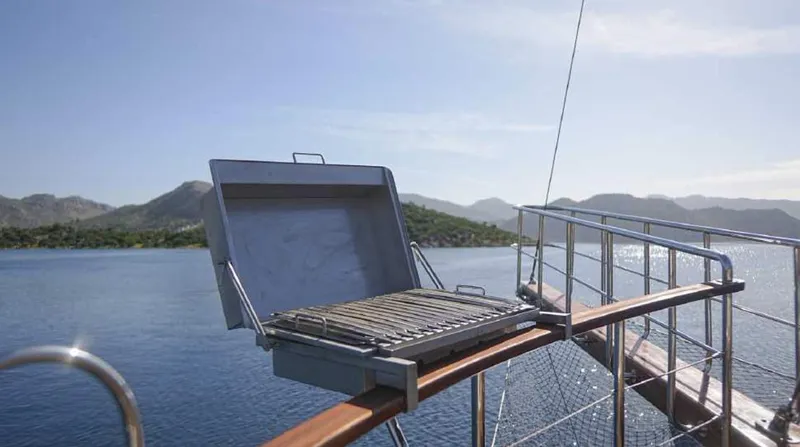  Yacht Photos Pics Outdoor grill on a 2023 Gulet yacht with scenic ocean and mountain views.