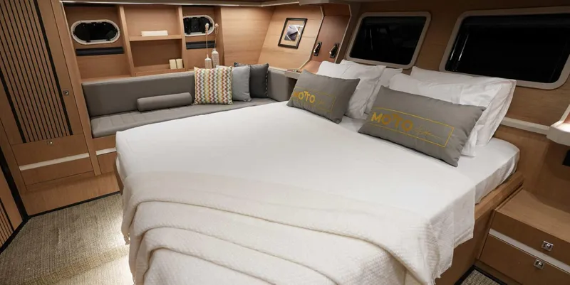  Yacht Photos Pics Luxurious 2023 Gulet yacht bedroom with cozy bed and elegant wooden interior design.