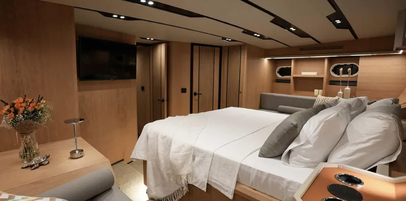  Yacht Photos Pics Luxurious 2023 Gulet yacht cabin with modern decor, cozy bed, and ambient lighting.