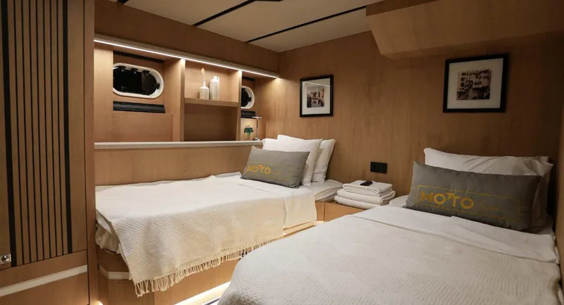  Yacht Photos Pics Luxurious 2023 Gulet cabin with twin beds, modern decor, and ambient lighting.