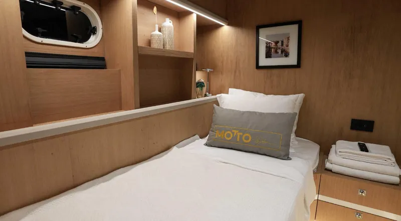  Yacht Photos Pics 2023 Gulet GULET cabin interior with cozy bed, wooden decor, and modern amenities.