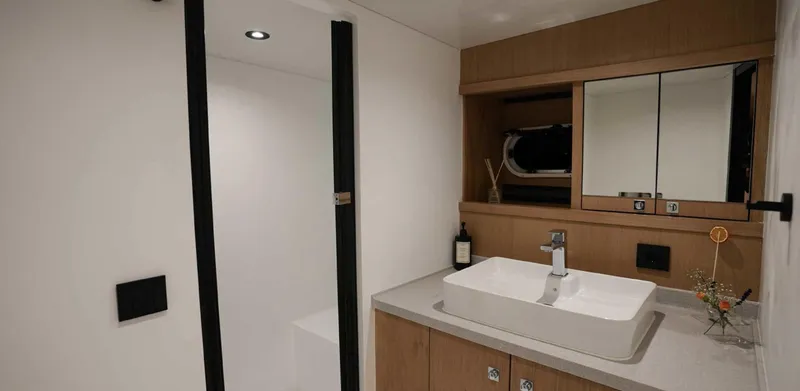  Yacht Photos Pics Modern bathroom interior on 2023 Gulet yacht with sleek sink and mirror.