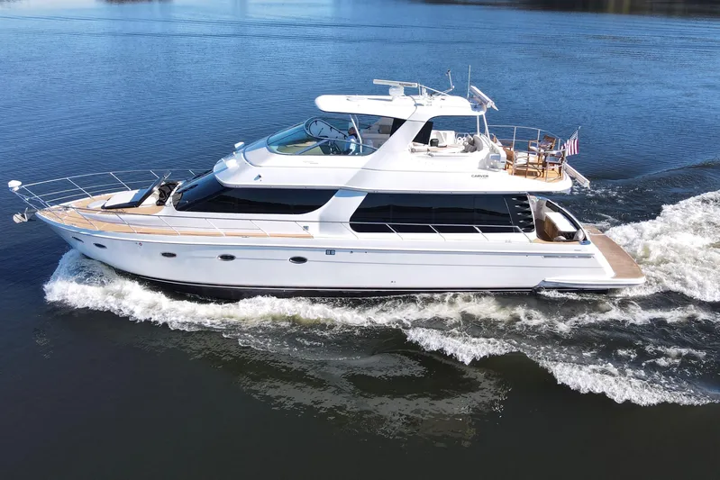  Yacht Photos Pics 2002 Carver 570 Voyager Pilothouse yacht cruising on calm waters.