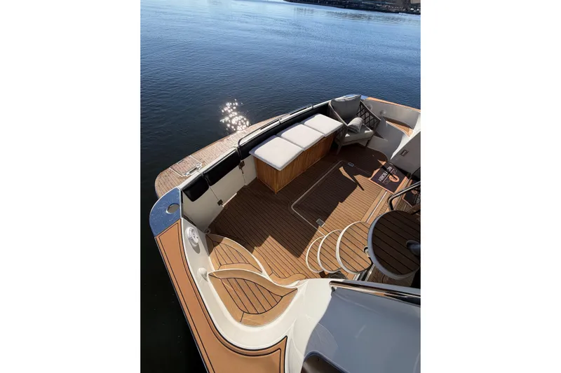  Yacht Photos Pics Luxurious 2002 Carver 570 Voyager Pilothouse yacht deck with seating, overlooking calm water.