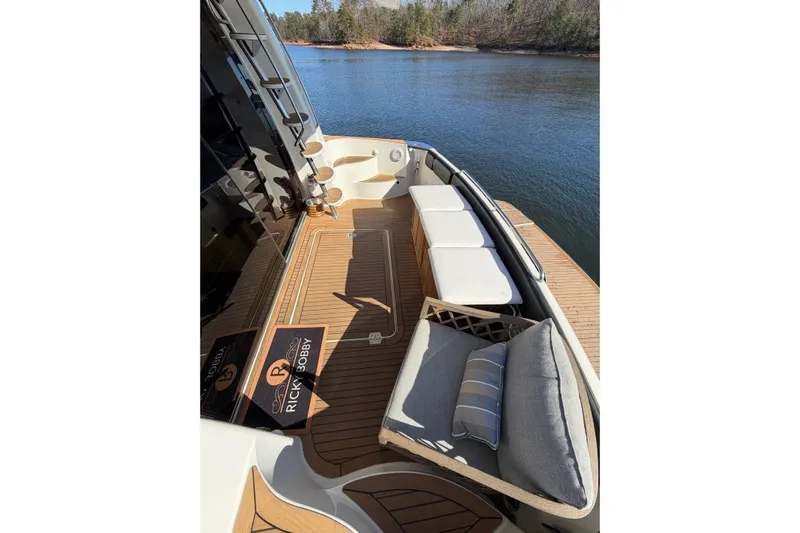  Yacht Photos Pics 2002 Carver 570 Voyager Pilothouse yacht deck with seating, on a serene lake.