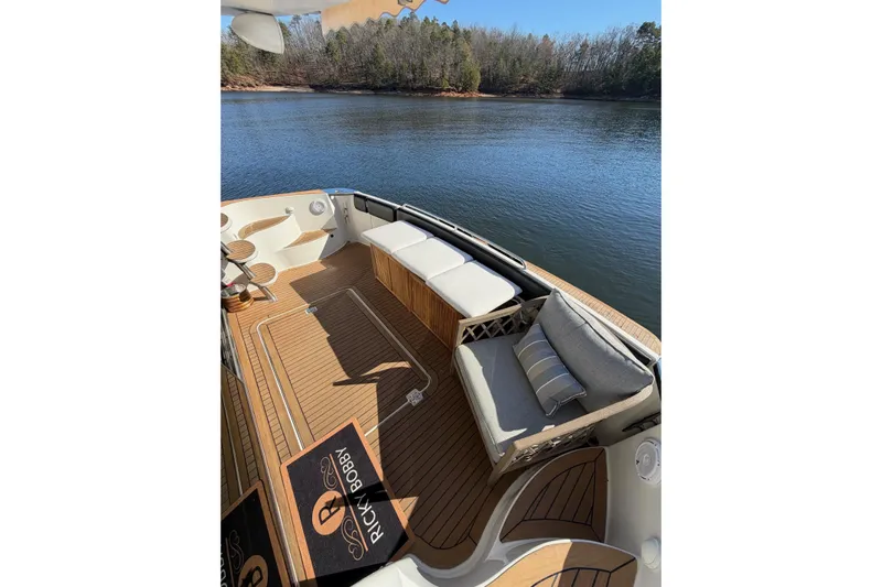  Yacht Photos Pics Luxurious 2002 Carver 570 Voyager Pilothouse yacht deck with seating, overlooking serene water.