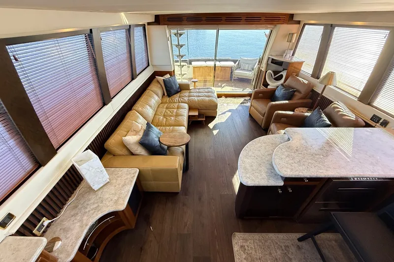  Yacht Photos Pics Luxurious interior of 2002 Carver 570 Voyager Pilothouse with leather seating and ocean view.
