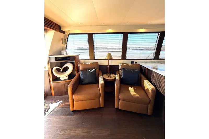  Yacht Photos Pics Luxurious interior of 2002 Carver 570 Voyager Pilothouse with leather chairs and large windows.