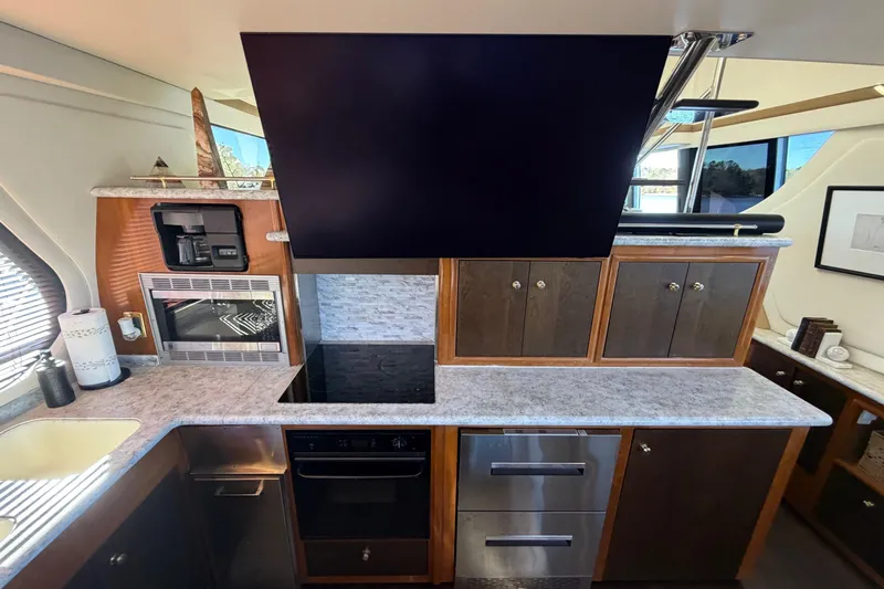  Yacht Photos Pics Luxurious kitchen interior of 2002 Carver 570 Voyager Pilothouse yacht with modern appliances.