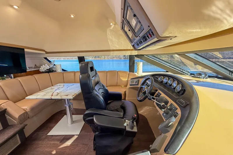  Yacht Photos Pics Luxurious 2002 Carver 570 Voyager Pilothouse interior with leather seating and modern helm.