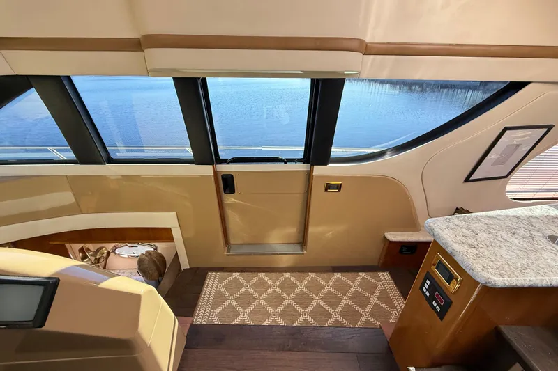  Yacht Photos Pics Interior of 2002 Carver 570 Voyager Pilothouse with lake view through large windows.