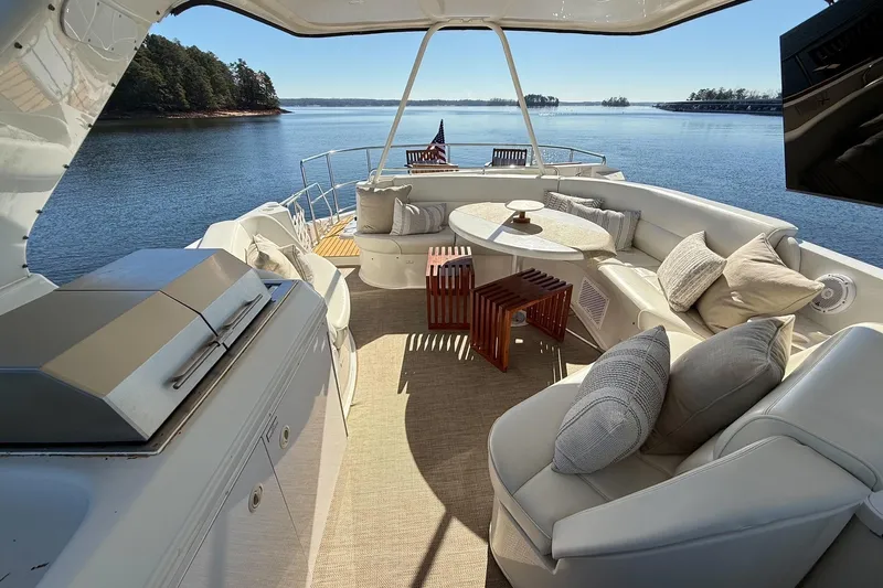  Yacht Photos Pics Luxurious 2002 Carver 570 Voyager Pilothouse yacht with elegant outdoor seating and scenic water view.