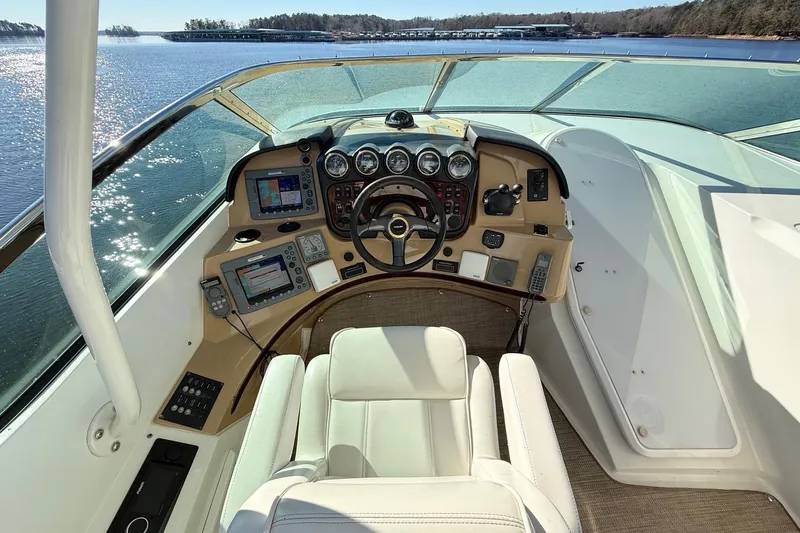  Yacht Photos Pics Pilothouse of 2002 Carver 570 Voyager, featuring modern navigation equipment and luxurious seating.