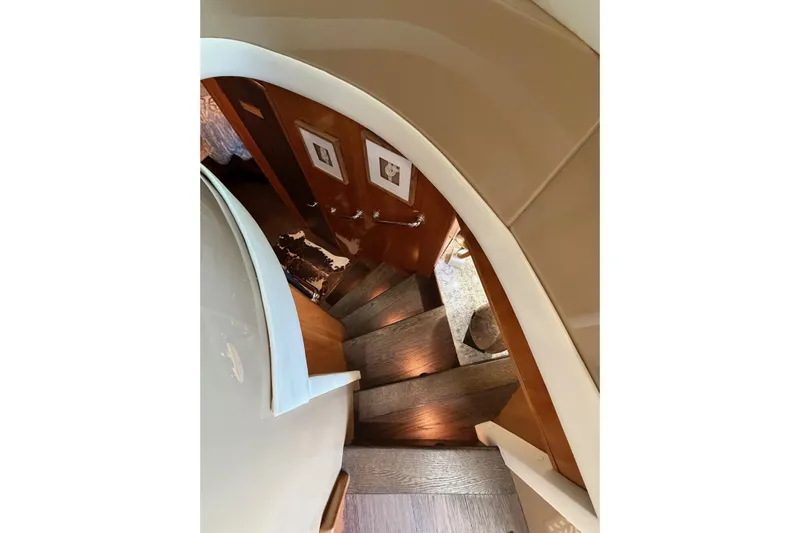  Yacht Photos Pics Staircase inside 2002 Carver 570 Voyager Pilothouse yacht, featuring elegant wood design.