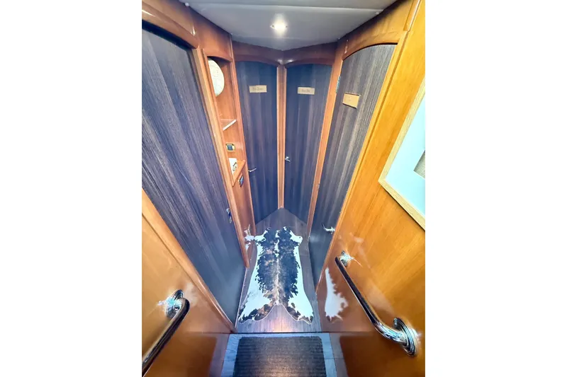  Yacht Photos Pics Luxurious interior hallway of 2002 Carver 570 Voyager Pilothouse yacht with wood paneling.