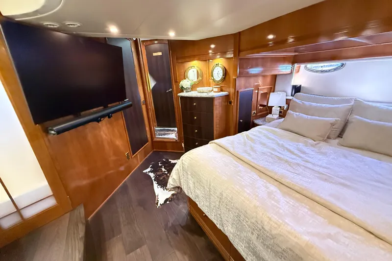  Yacht Photos Pics Luxurious bedroom interior of 2002 Carver 570 Voyager Pilothouse yacht with elegant wood finishes.