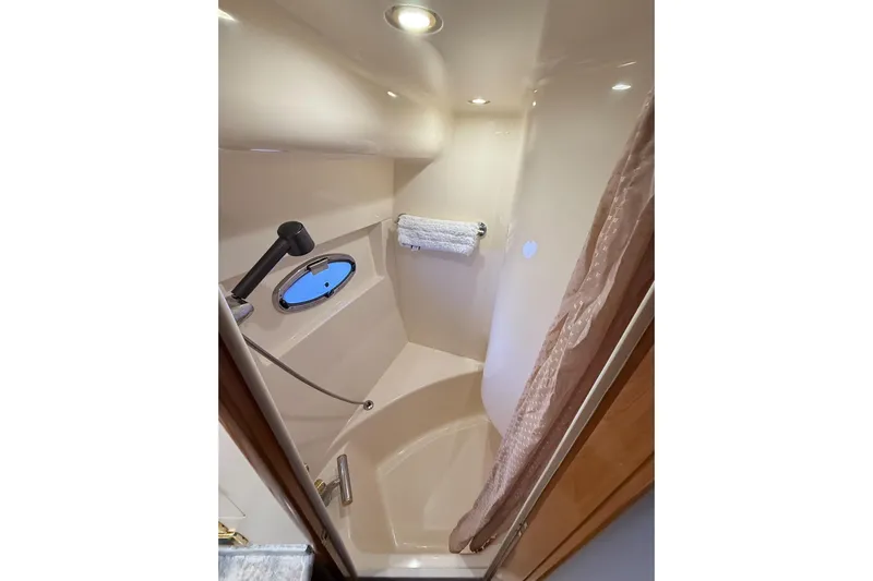  Yacht Photos Pics Bathroom interior of 2002 Carver 570 Voyager Pilothouse yacht with shower and porthole.