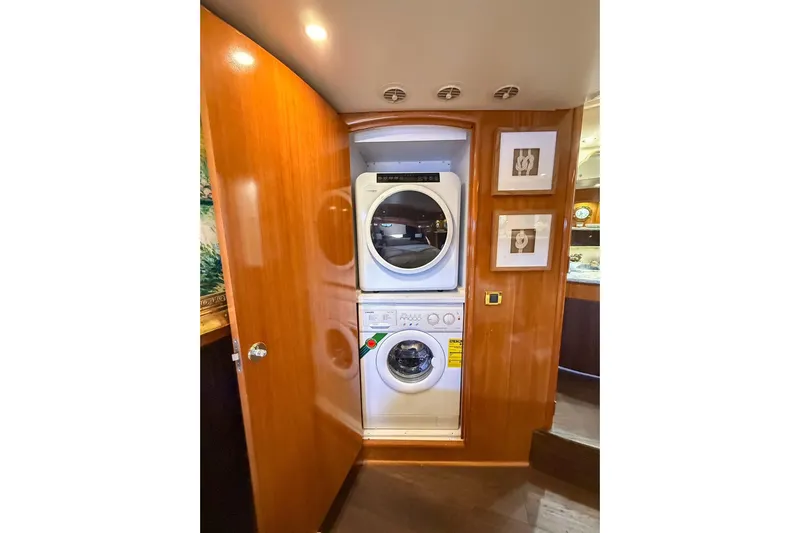 Yacht Photos Pics Laundry area inside 2002 Carver 570 Voyager Pilothouse yacht with stacked washer and dryer.