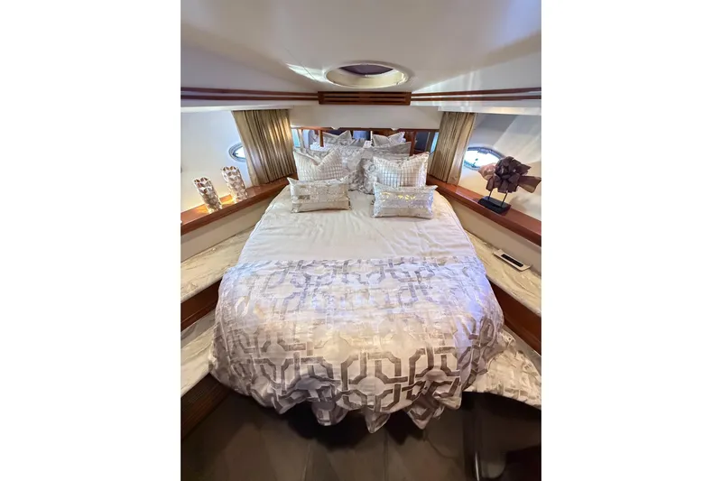  Yacht Photos Pics Luxurious bedroom interior of 2002 Carver 570 Voyager Pilothouse yacht with elegant bedding.