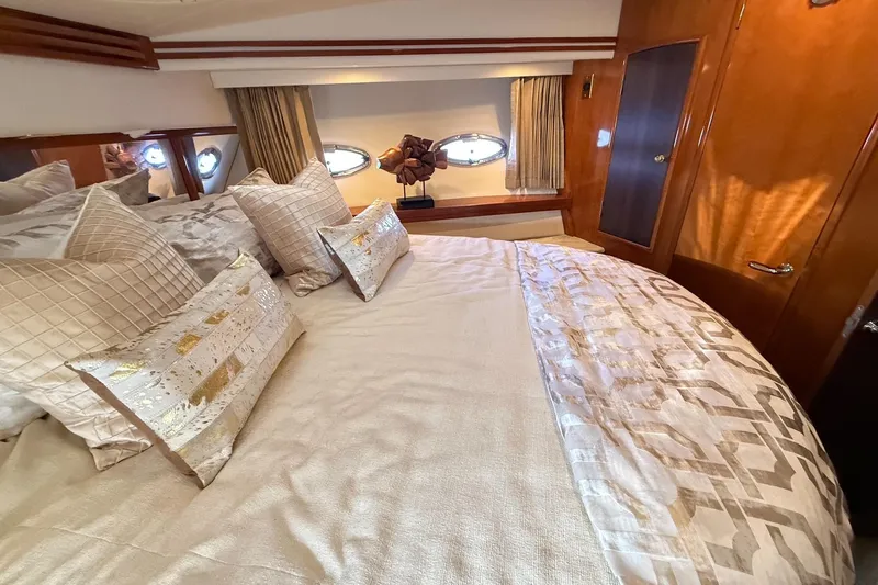  Yacht Photos Pics Luxurious bedroom interior of 2002 Carver 570 Voyager Pilothouse yacht with elegant bedding.