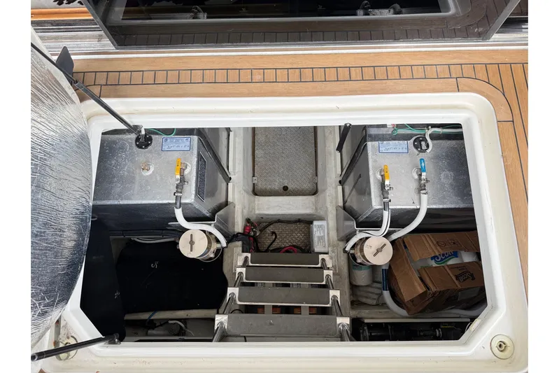  Yacht Photos Pics 2002 Carver 570 Voyager Pilothouse engine compartment with visible fuel tanks and equipment.