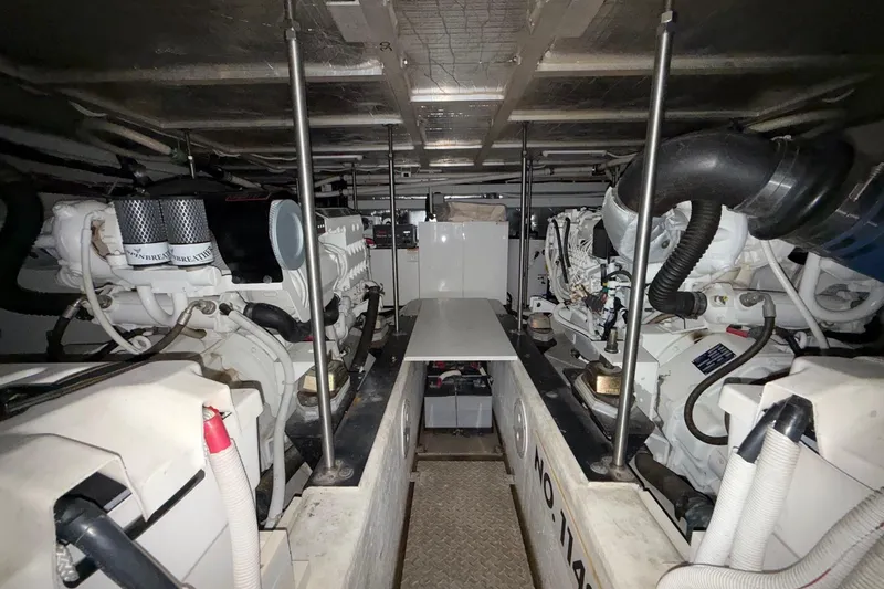  Yacht Photos Pics Engine room of 2002 Carver 570 Voyager Pilothouse, showcasing dual engines and mechanical components.