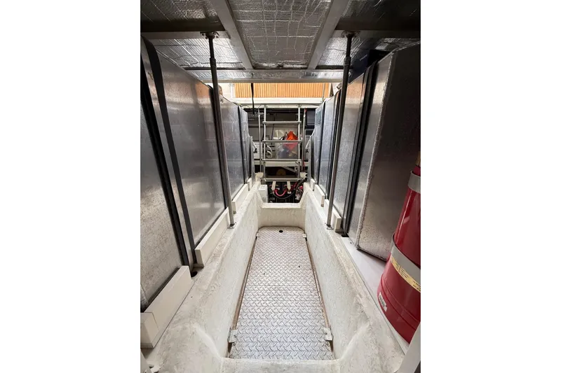  Yacht Photos Pics Engine room of 2002 Carver 570 Voyager Pilothouse with visible equipment and storage.